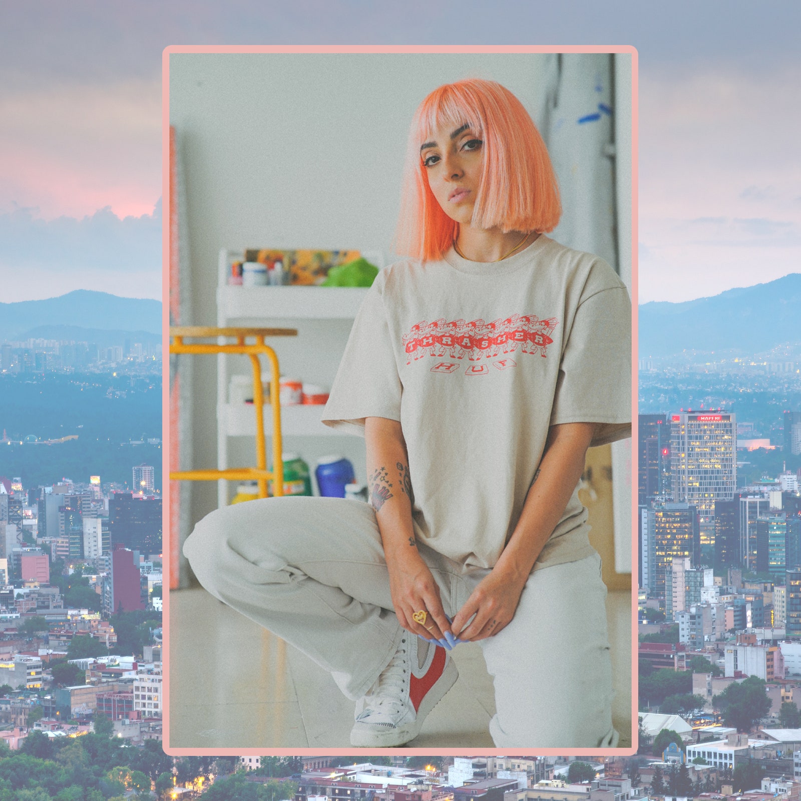 A person with pink hair on a background of a city